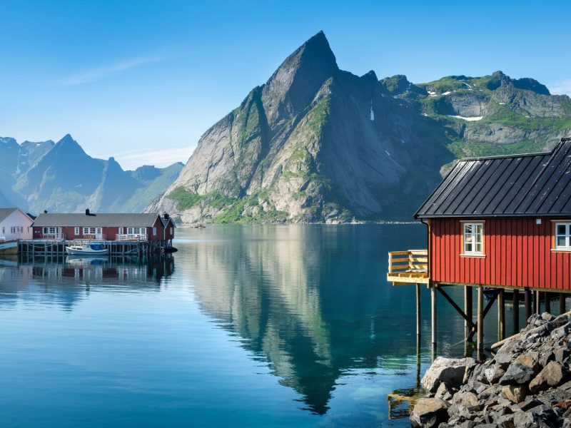 Scenic view from idyllic village with mountains at bright summer day in Hamnoy, Lofoten, Norway