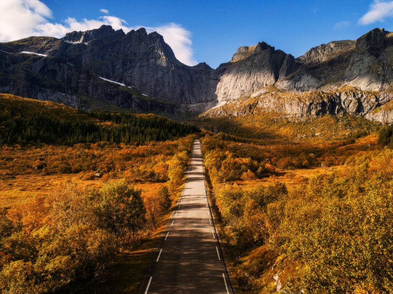 Scenic road to the village of Nusfjord on Lofoten islands in Norway on a sunny autumn day.