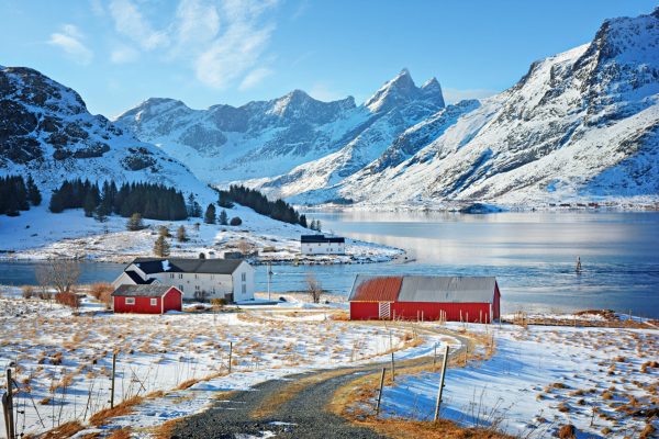 Beautiful winter landscape with traditional Norwegian fishing hut in the mountains of Lofoten islands in Norwegian Sea, Norway