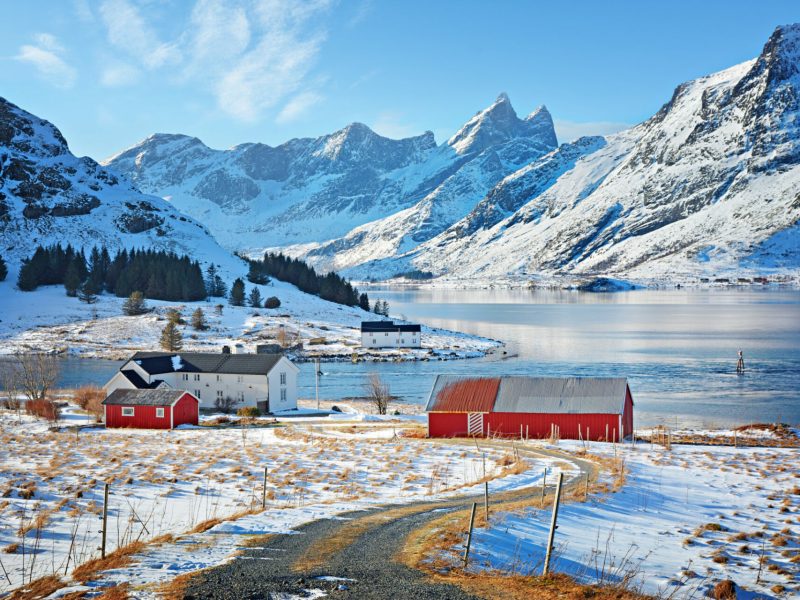 Beautiful winter landscape with traditional Norwegian fishing hut in the mountains of Lofoten islands in Norwegian Sea, Norway